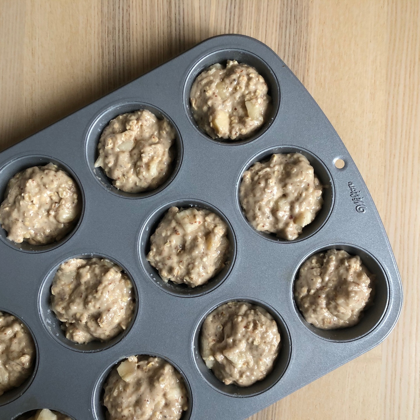 Pear and cardamom muffins in tin