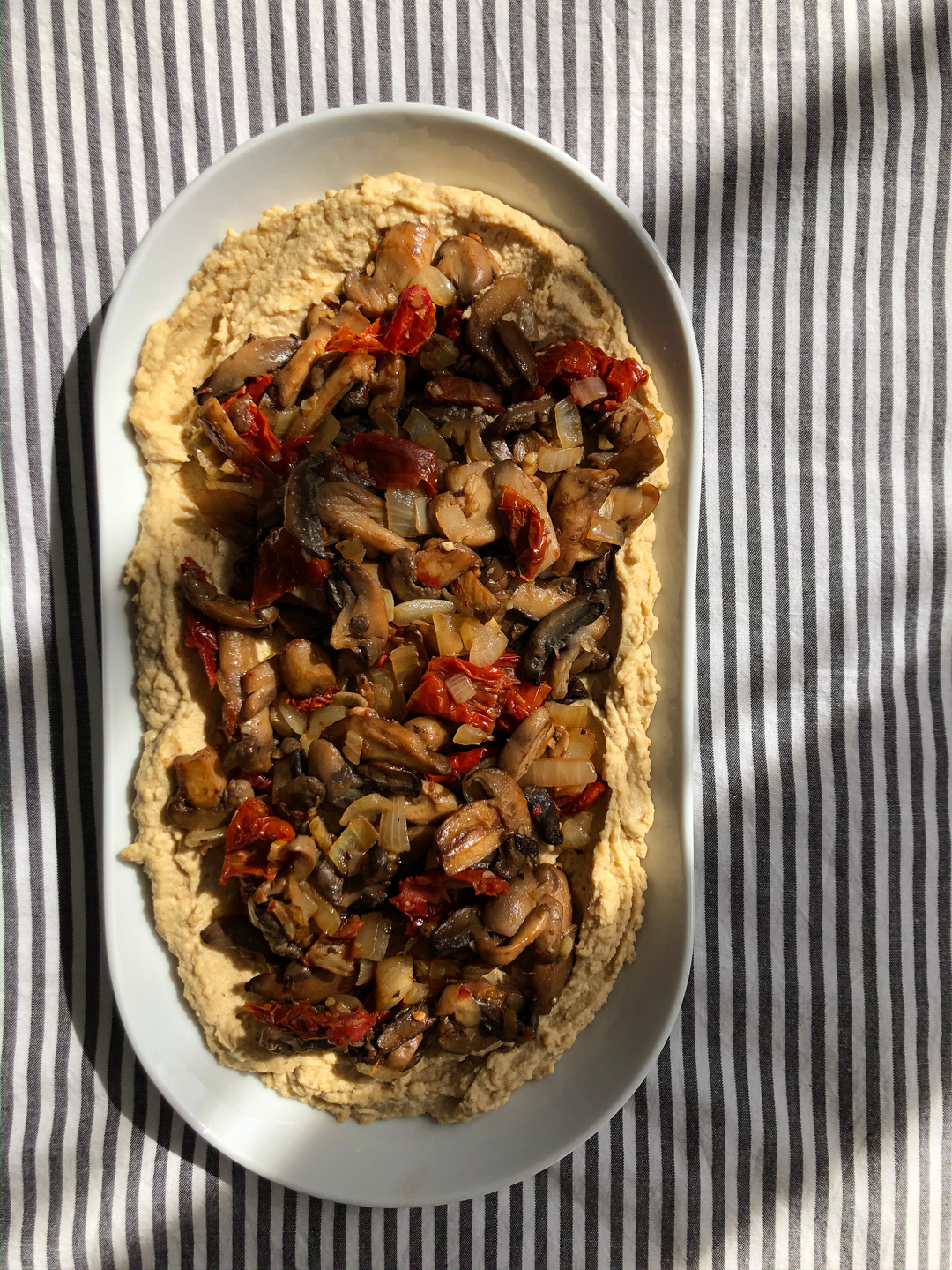 loaded hummus with mushrooms and sun-dried tomatoes