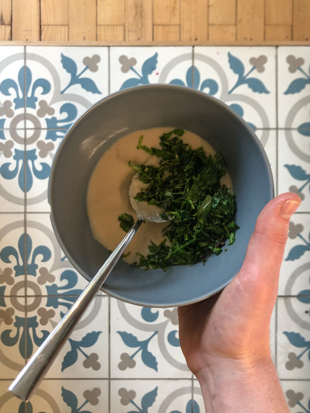 mixing herbs and tahini for the pasta sauce